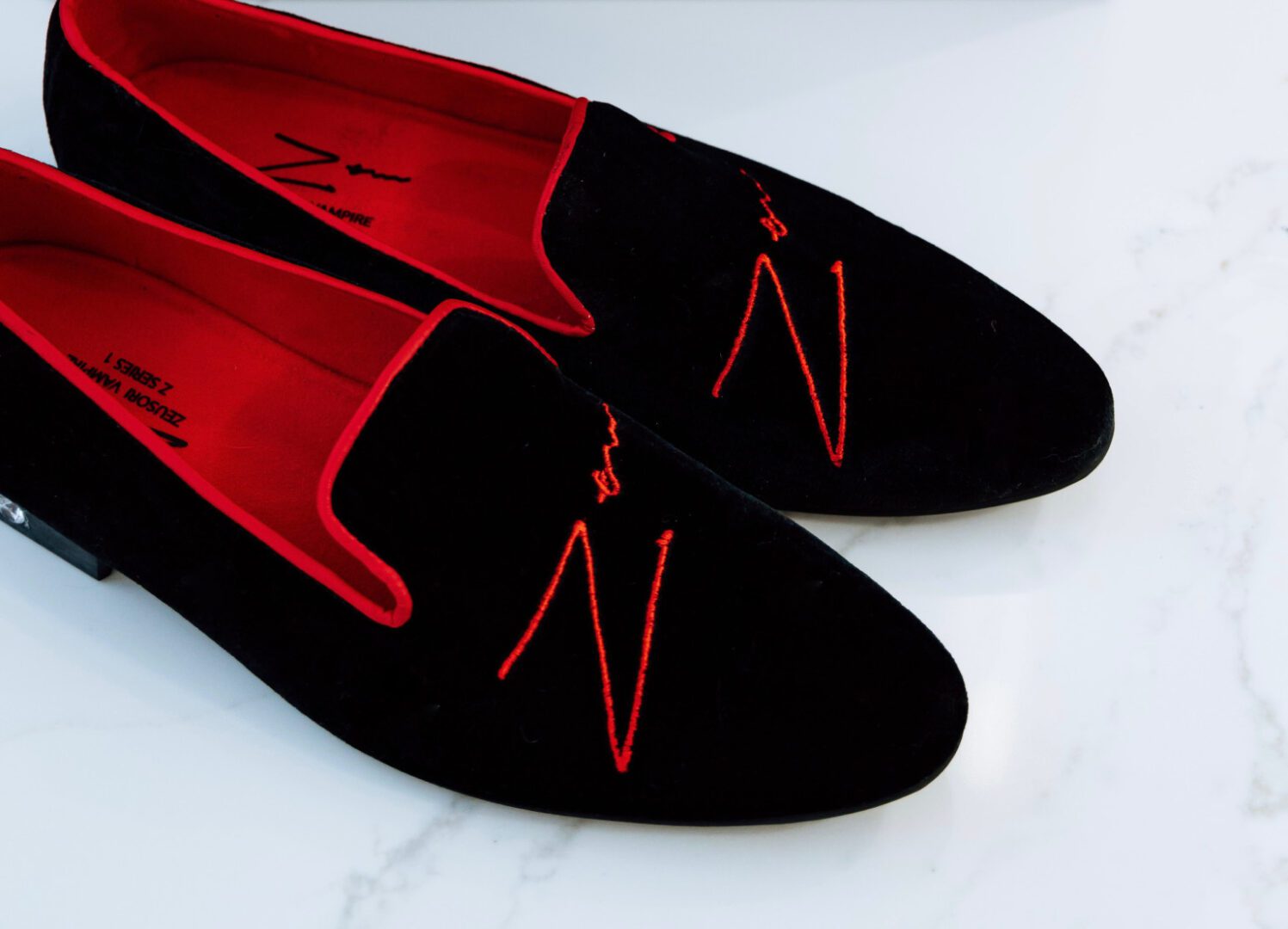 A pair of Zeusori low heel velvet loafers on the floor