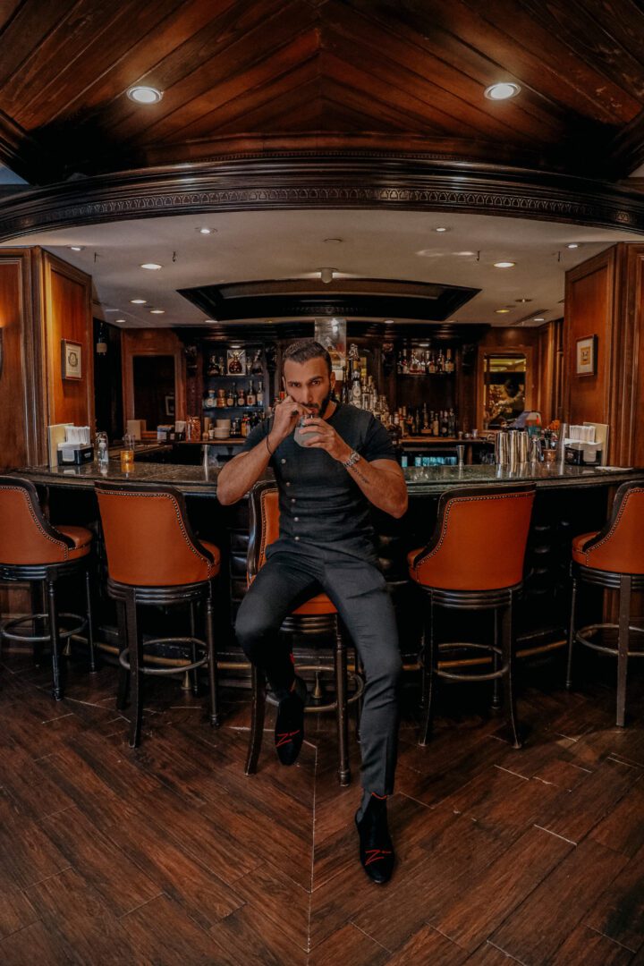 A man sitting at the bar and drinking