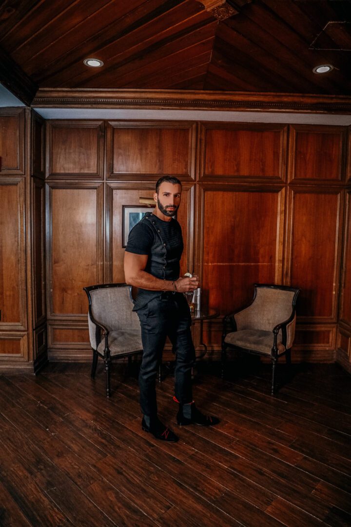 A man wearing a black color loafer posing for a picture