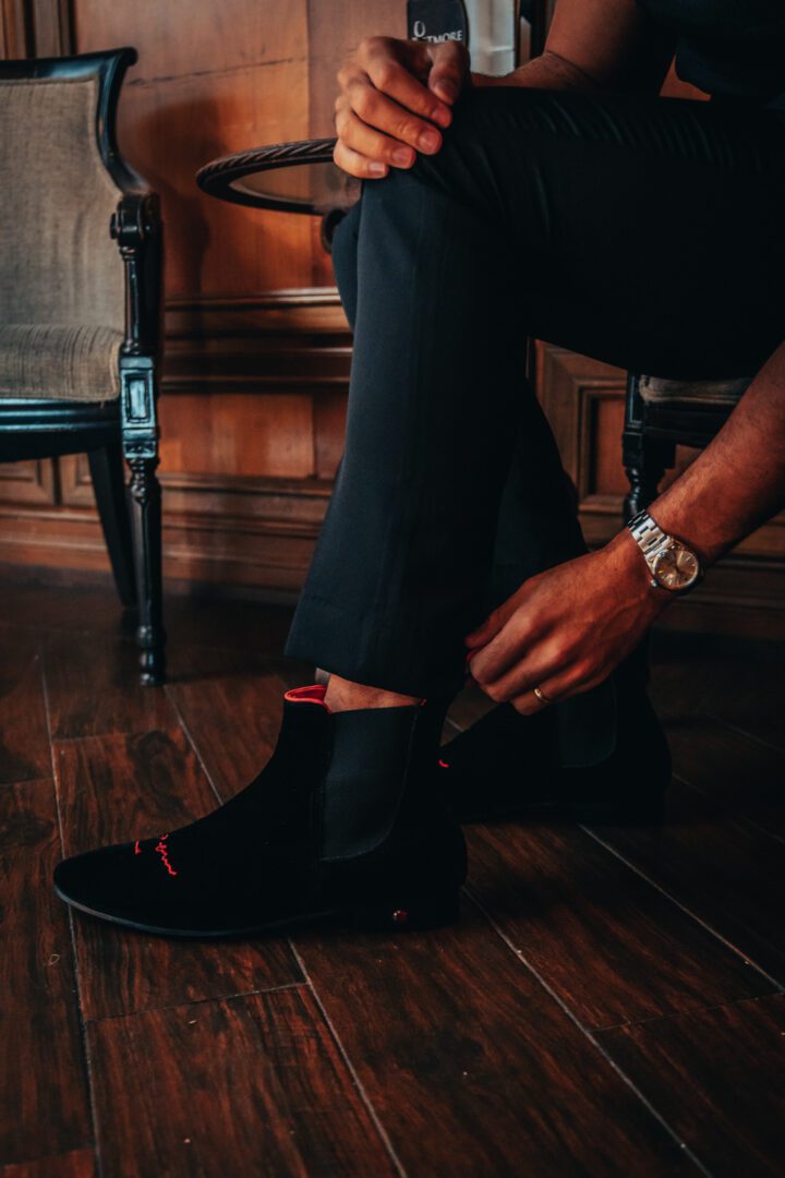 A picture of the man sitting and wearing the loafers