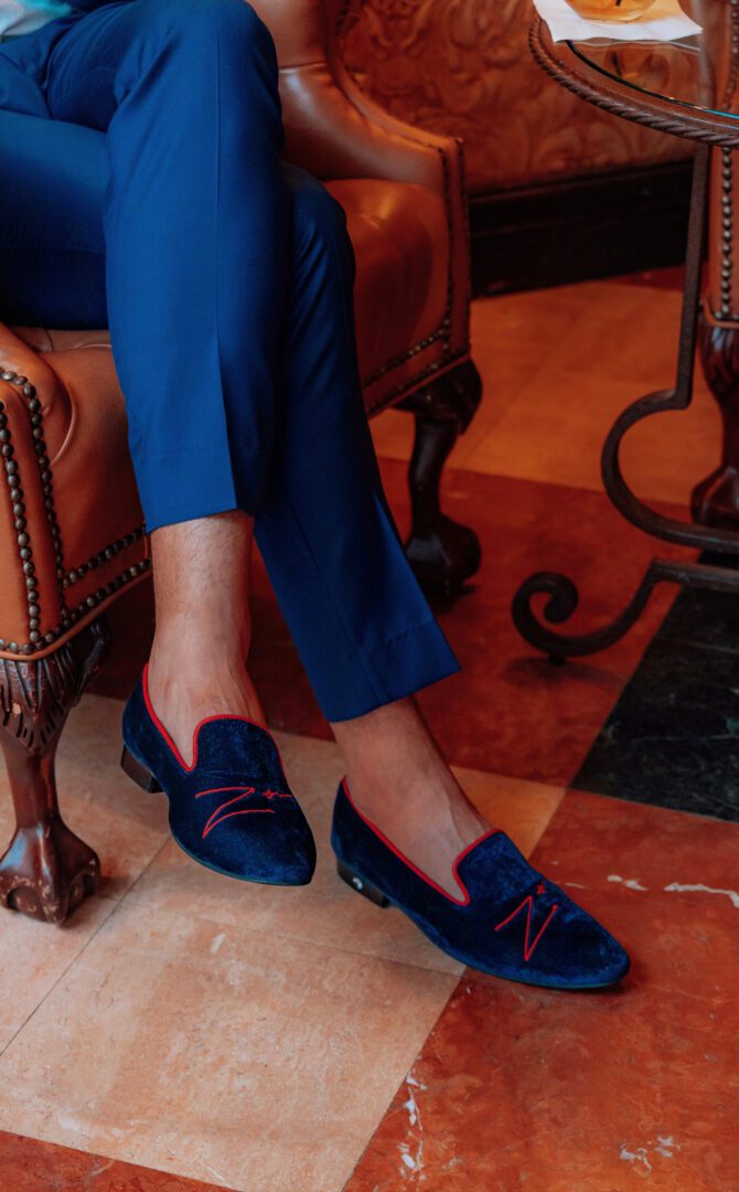 A picture of the man in blue and red color velvet loafers