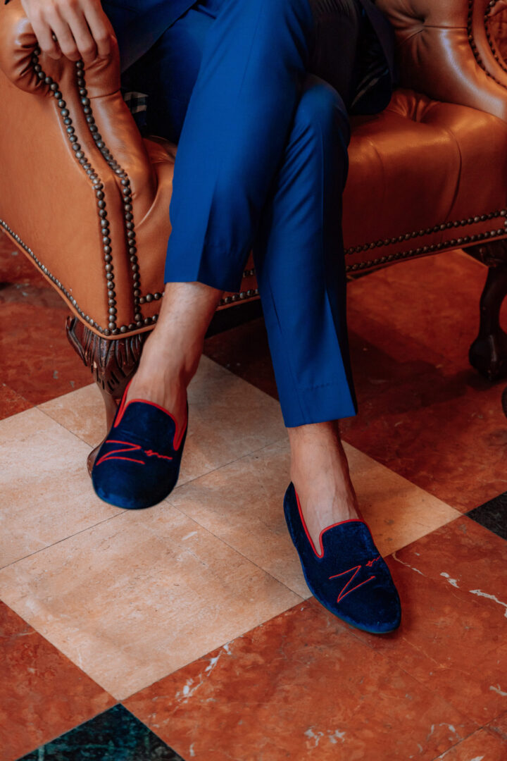 A picture of the man in blue color velvet loafers