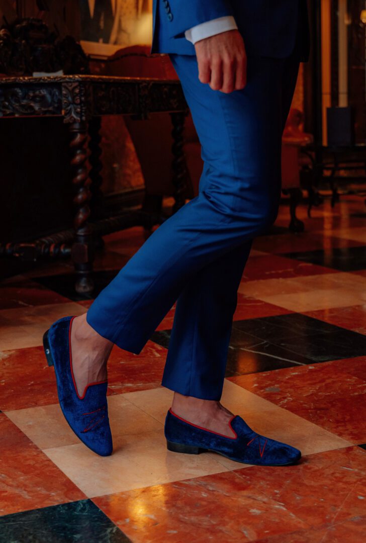 A man standing with blue color velvet loafer