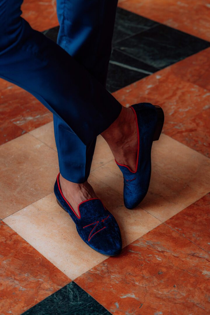 A man wearing blue color low heel cut velvet loafer