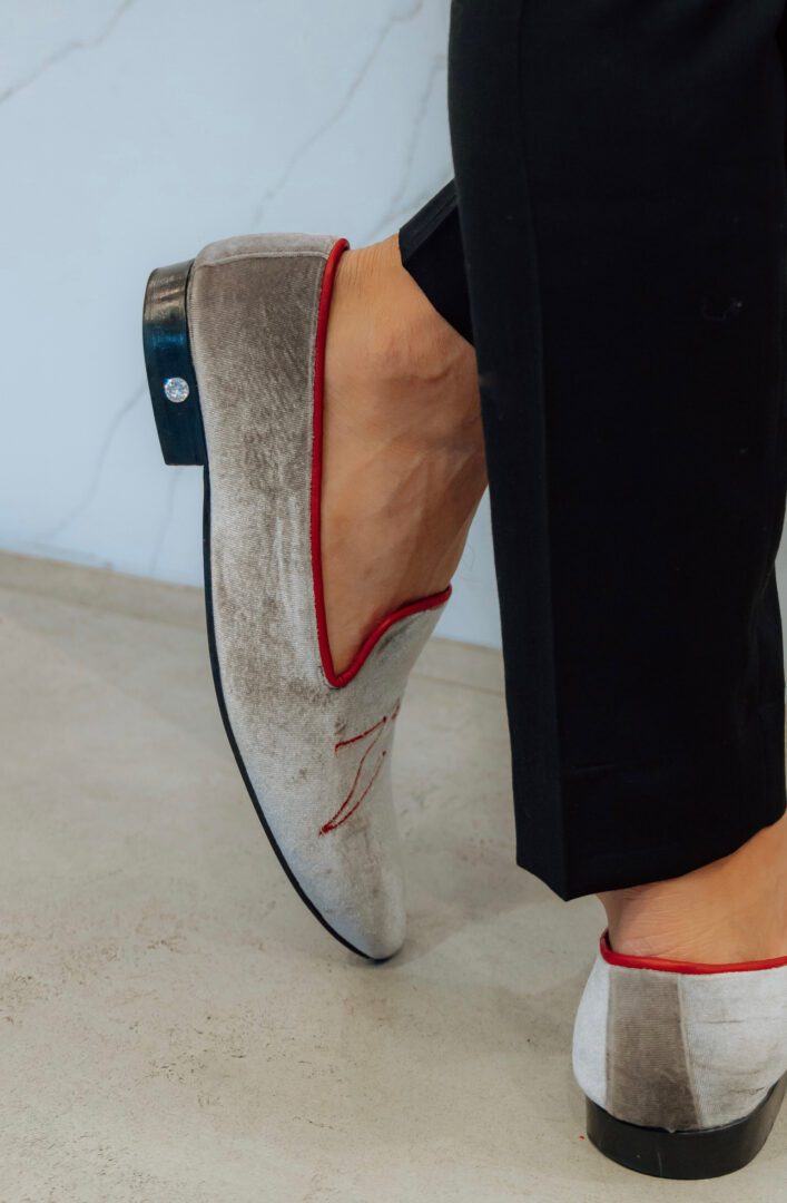 A picture of the man in grey and red color loafers